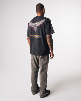 bunjil the wedged-tailed eagle t-shirt in a washed out black color being worn in a side quarter image displaying fit and practically art on the back