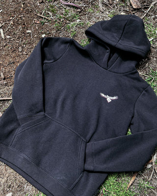 bunjil the wedged-tailed eagle hoodie placed on the floor in a close up detailed shot image displaying murrundindi eagle logo.